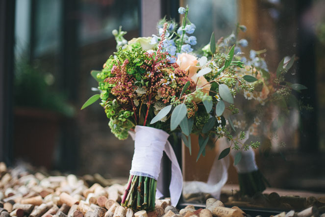 Hand-tied bouquet light peach roses, fever few and blue delphinium