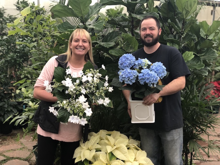 Trevor and Jenn with blooming plants for the holidays